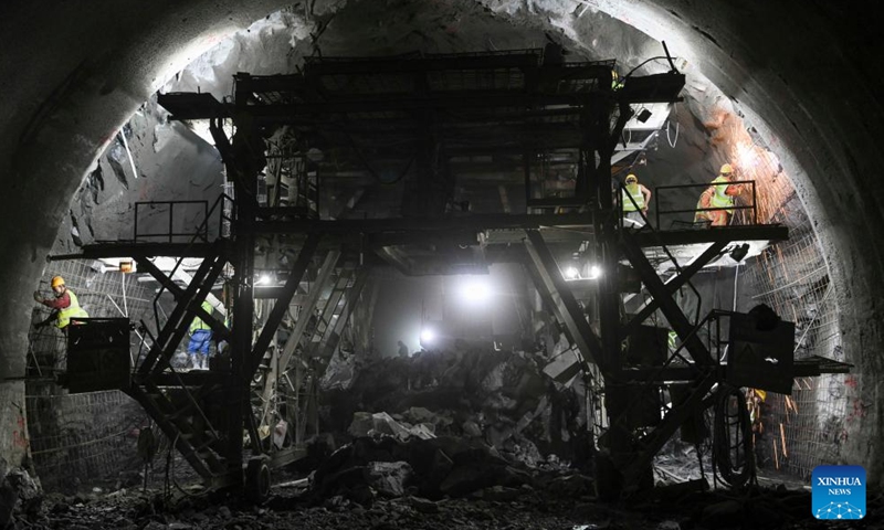 Workers operate at the construction site of Tianshan Shengli tunnel along the expressway linking Urumqi and Yuli County in northwest China's Xinjiang Uygur Autonomous Region, Dec. 25, 2024.The 22.13-km Tianshan Shengli tunnel, world's longest expressway tunnel, will soon be drilled through. (Xinhua/Hu Huhu)