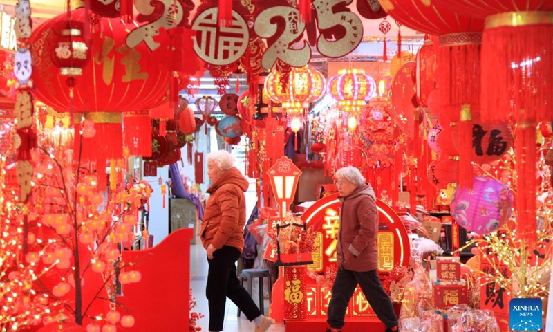 Customers buy festive decorations at a market in Nanjing, east China's Jiangsu Province, Dec. 29, 2024. China is gearing up for the upcoming New Year 2025 with festive decorations and various activities nationwide. (Photo by Liu Jianhua/Xinhua)