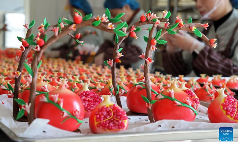 Artisans make pomegranate-shaped festive buns in Zaozhuang, east China's Shandong Province, Dec. 29, 2024. China is gearing up for the upcoming New Year 2025 with festive decorations and various activities nationwide. (Photo by Wang Hainan/Xinhua)