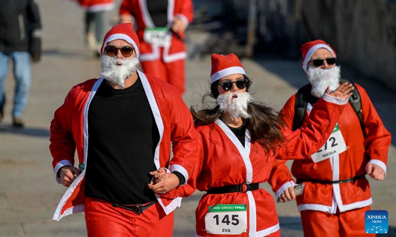 People dressed as Santa Clauses run during the traditional Santa race in Skopje, North Macedonia, Dec. 29, 2024. (Photo by Tomislav Georgiev/Xinhua)