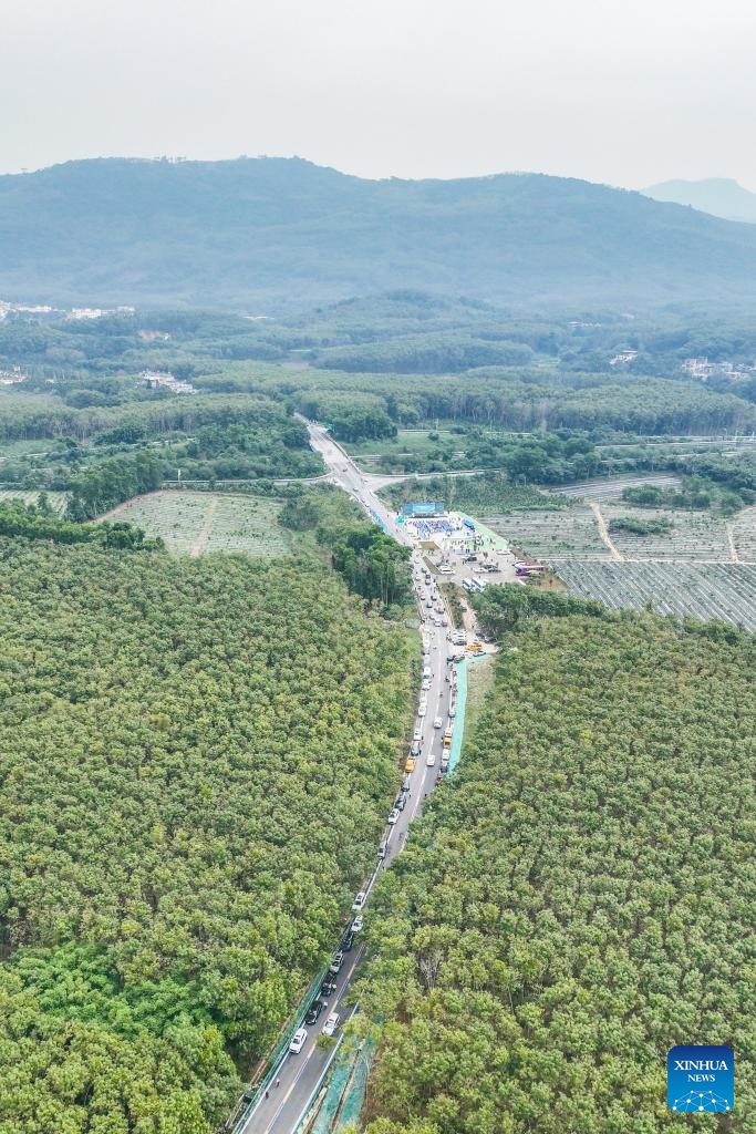 An aerial drone photo taken on Dec. 29, 2024 shows the Qiongzhong section of a ring road surrounding the national tropical rain forest park in south China's Hainan Province.