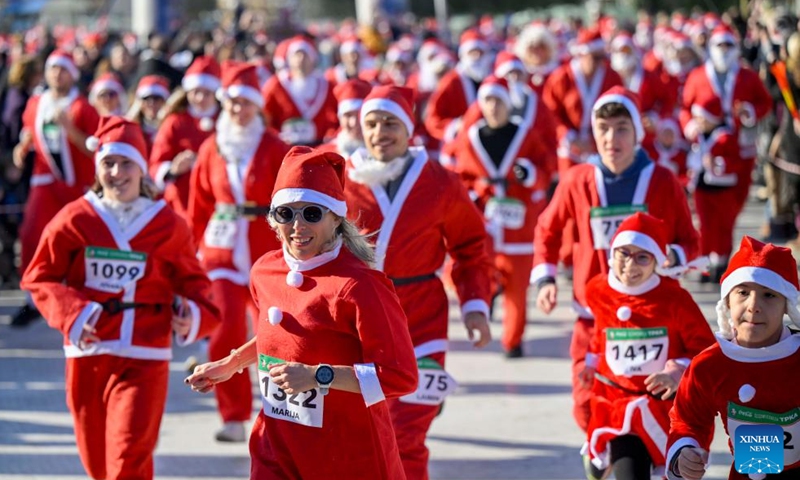 People dressed as Santa Clauses run during the traditional Santa race in Skopje, North Macedonia, Dec. 29, 2024. (Photo by Tomislav Georgiev/Xinhua)