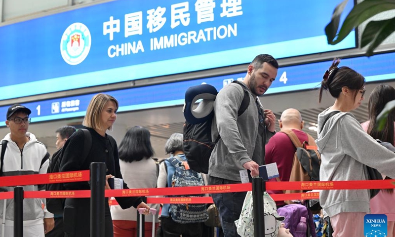 Tourists from Singapore wait for immigration clearance at the Meilan International Airport in Haikou, south China's Hainan Province, Dec. 28, 2024.