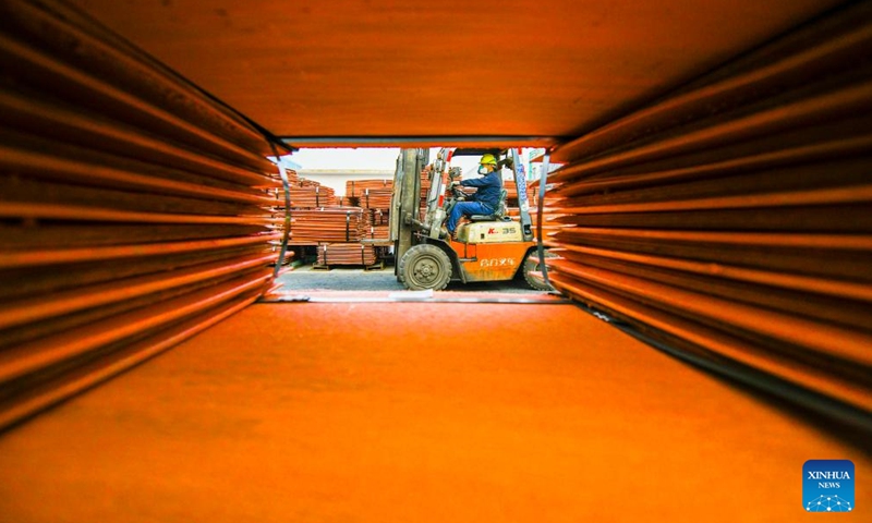 A worker drives a forklift to transfer cathode copper at a Hunan branch of China Minmetals in Changning City, central China's Hunan Province, Jan. 2, 2025. Enterprises across China are operating at full capacity to meet production demands at the start of the new year. (Photo by Zhou Xiuyuchun/Xinhua)