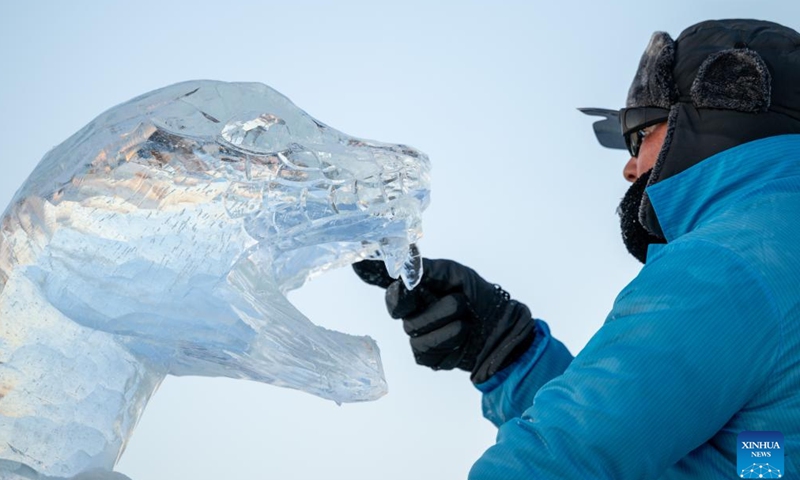 A competitor works on an ice sculpture during the 36th China Harbin International Ice Sculpture Competition at Harbin Ice-Snow World in Harbin, northeast China's Heilongjiang Province, Jan. 3, 2025. A total of 30 teams from 12 countries and regions participated in the competition. (Xinhua/Zhang Tao)