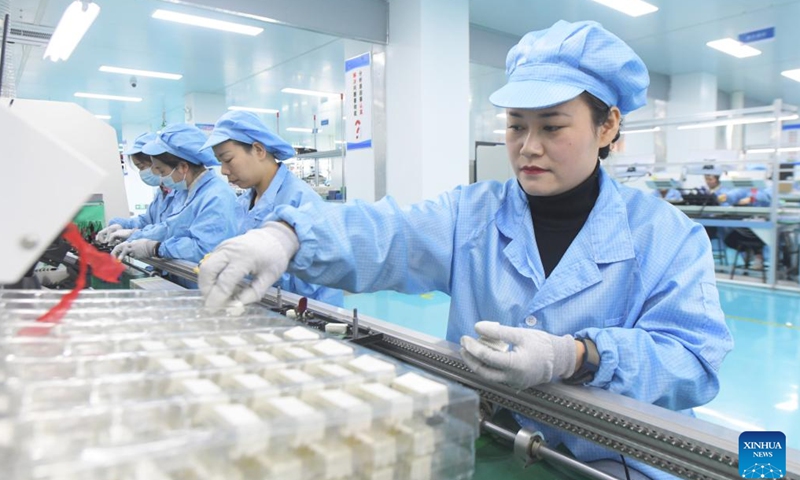 Workers fulfill export orders at a workshop of an automotive electronics company in Shijiazhuang, north China's Hebei Province, Jan. 2, 2025. Enterprises across China are operating at full capacity to meet production demands at the start of the new year. (Photo by Jia Minjie/Xinhua)