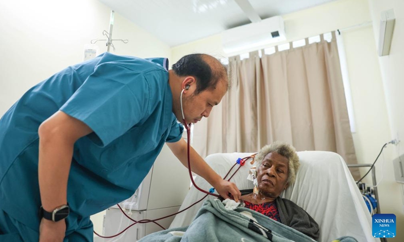 Wang Rui (L), deputy leader of the Chinese medical team and an expert on respiratory and critical care medicine, auscultates a patient at Vila Central, the main hospital in Port Vila, Vanuatu, Jan. 2, 2025. 