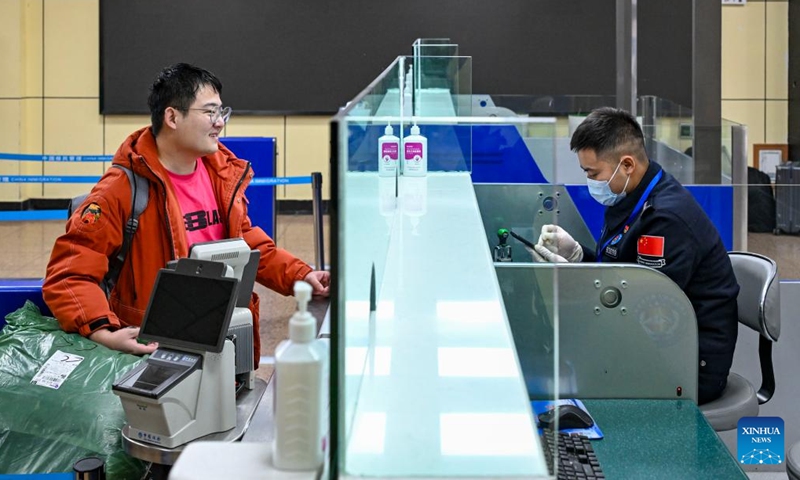 A passenger for Pakistan has his travel documents checked at the Khunjerab Pass in Taxkorgan Tajik Autonomous County, northwest China's Xinjiang Uygur Autonomous Region, Jan. 2, 2025.