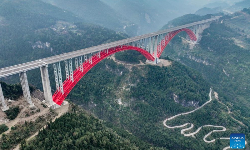 This aerial drone photo taken on Jan. 1, 2025 shows the Shuangbu super major bridge of the second expressway connecting southwest China's Chongqing Municipality and central China's Hunan Province. The second Chongqing-Hunan expressway saw its 127-km Banan-Wulong section and 91.6-km Pengshui-Youyang section, both in Chongqing, opened to public traffic on Thursday. The whole expressway, with a length of 280 kilometers, is expected to put in full operation within 2025. (Xinhua/Tang Yi)