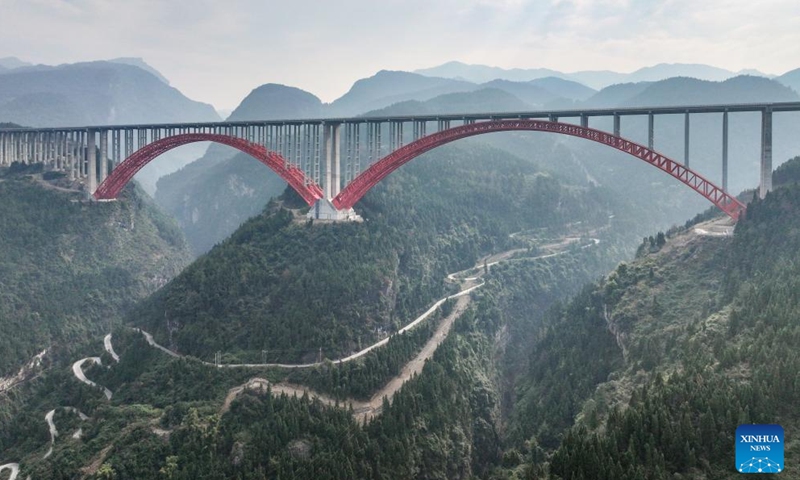 This aerial drone photo taken on Jan. 1, 2025 shows the Shuangbu super major bridge of the second expressway connecting southwest China's Chongqing Municipality and central China's Hunan Province. The second Chongqing-Hunan expressway saw its 127-km Banan-Wulong section and 91.6-km Pengshui-Youyang section, both in Chongqing, opened to public traffic on Thursday. The whole expressway, with a length of 280 kilometers, is expected to put in full operation within 2025. (Xinhua/Tang Yi)