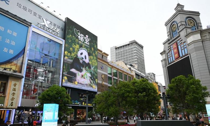 This photo taken on April 3, 2024 shows a screen with a photo of giant panda Fu Bao at a commercial street in Chengdu, southwest China's Sichuan Province. (Xinhua/Xu Bingjie)