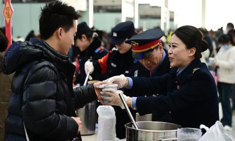 Staff members serve Laba porridge for passengers at Hefei South Railway Station in Hefei, east China's Anhui Province, Jan. 6, 2025. Various activities were held across the country to welcome the upcoming Laba Festival that falls on Jan. 7 this year. (Xinhua/Zhou Mu)