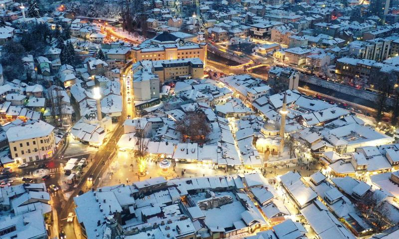 An aerial drone photo taken on Jan. 5, 2025 shows a winter view in Sarajevo, Bosnia and Herzegovina. Sarajevo is the capital and largest city of Bosnia and Herzegovina. Located in the east-central part of Bosnia and Herzegovina, it is situated in a hilly area, surrounded by mountains, with a population of about 300,000. (Xinhua/Yin Xiaosheng)