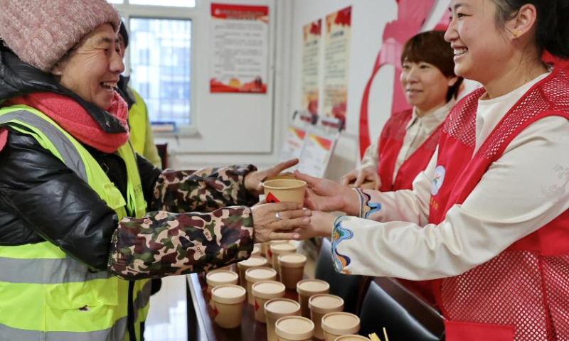 Volunteers serve free Laba porridge for sanitation workers in Haigang District of Qinhuangdao, north China's Hebei Province, Jan. 6, 2025. Various activities were held across the country to welcome the upcoming Laba Festival that falls on Jan. 7 this year. (Photo by Cao Jianxiong/Xinhua)

