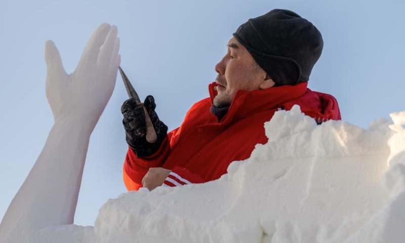 A contestant works on a snow sculpture at the Sun Island International Snow Sculpture Art Expo park in Harbin, northeast China's Heilongjiang Province, Jan. 6, 2025. The 27th Harbin international snow sculpture competition kicked off on Monday, attracting snow sculptors of more than 20 teams from 10 countries. (Xinhua/Zhang Tao)