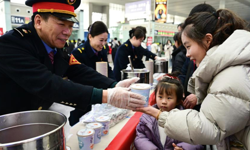 Staff members serve Laba porridge for passengers at Hefei South Railway Station in Hefei, east China's Anhui Province, Jan. 6, 2025. Various activities were held across the country to welcome the upcoming Laba Festival that falls on Jan. 7 this year. (Xinhua/Zhou Mu)