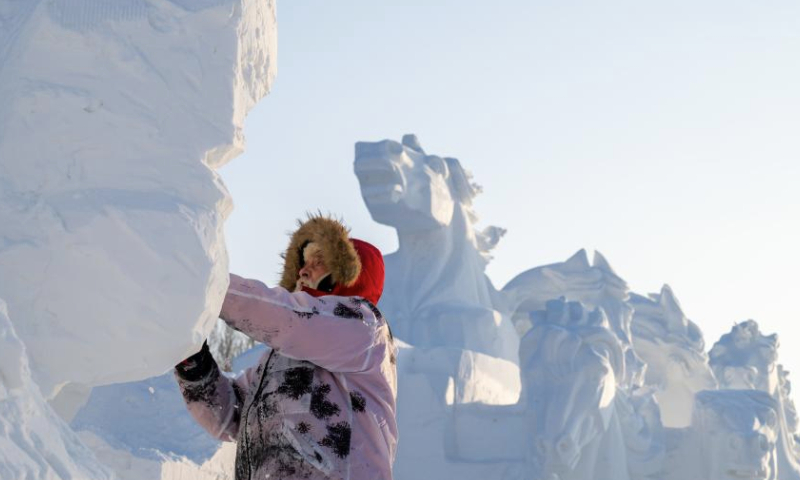 A contestant works on a snow sculpture at the Sun Island International Snow Sculpture Art Expo park in Harbin, northeast China's Heilongjiang Province, Jan. 6, 2025. The 27th Harbin international snow sculpture competition kicked off on Monday, attracting snow sculptors of more than 20 teams from 10 countries. (Xinhua/Zhang Tao)