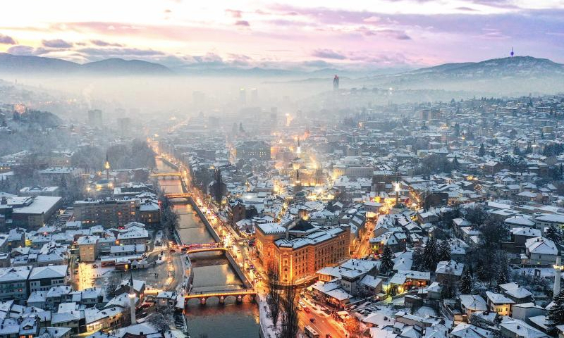 An aerial drone photo taken on Jan. 5, 2025 shows a winter view in Sarajevo, Bosnia and Herzegovina. Sarajevo is the capital and largest city of Bosnia and Herzegovina. Located in the east-central part of Bosnia and Herzegovina, it is situated in a hilly area, surrounded by mountains, with a population of about 300,000. (Xinhua/Yin Xiaosheng)