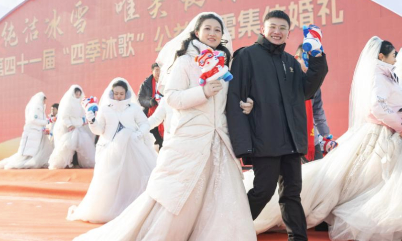 Loving couples take part in a group wedding at the Harbin Ice-Snow World in Harbin, northeast China's Heilongjiang Province, Jan. 6, 2025. A free group wedding which is part of the Harbin International Ice and Snow Festival was held at the Harbin Ice-Snow World on Monday. The winter-themed event was participated by 43 couples from 17 provinces, municipalities or regions in China. (Xinhua/Xie Jianfei)