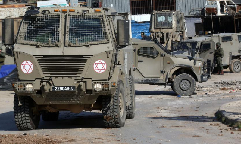 Vehicles of Israeli forces are seen on a street during an Israeli operation in Far'a refugee camp, south of the West Bank City of Tubas, on Jan. 7, 2025. Palestinian sources said Israeli forces launched a large-scale operation at dawn in the Far'a refugee camp and surrounding areas in Tubas on Tuesday. (Photo by Nidal Eshtayeh/Xinhua)