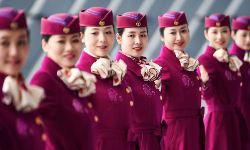 High-speed railway crew members take part in an etiquette training in Chongqing, southwest China, Jan. 8, 2025. The Chongqing branch of China Railway Chengdu Bureau Group Co., Ltd. organized training programs for high-speed railway crew members to improve service quality and prepare for the upcoming Spring Festival travel rush. (Xinhua/Wang Quanchao)