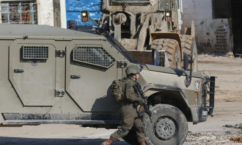 Vehicles of Israeli forces are seen on a street during an Israeli operation in Far'a refugee camp, south of the West Bank City of Tubas, on Jan. 7, 2025. Palestinian sources said Israeli forces launched a large-scale operation at dawn in the Far'a refugee camp and surrounding areas in Tubas on Tuesday. (Photo by Nidal Eshtayeh/Xinhua)