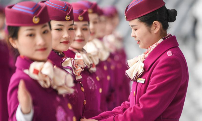 High-speed railway crew members take part in an etiquette training in Chongqing, southwest China, Jan. 8, 2025. The Chongqing branch of China Railway Chengdu Bureau Group Co., Ltd. organized training programs for high-speed railway crew members to improve service quality and prepare for the upcoming Spring Festival travel rush. (Xinhua/Wang Quanchao)