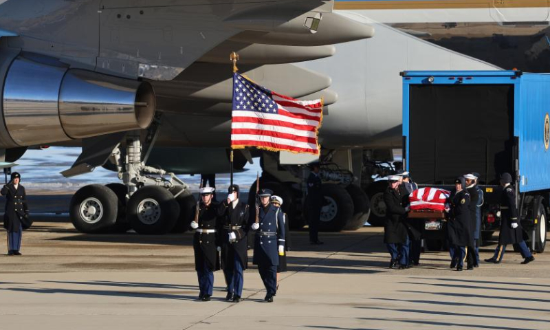 A joint forces body bearer team moves former U.S. President Jimmy Carter's coffin upon arrival at Joint Base Andrews in Maryland, the United States, on Jan. 7, 2025. The body of former U.S. President Jimmy Carter, who recently passed away at the age of 100, arrived in Washington, D.C. on Tuesday. A presidential jet departed from Atlanta, Georgia, earlier in the day and landed at Joint Base Andrews in Maryland, just outside the capital, Tuesday afternoon. (Xinhua/Hu Yousong)