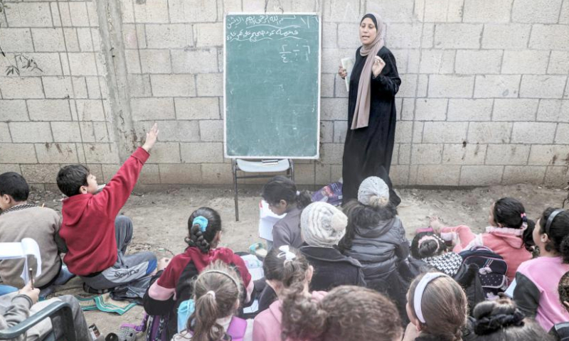 Palestinian students study at temporary shelter in Deir al