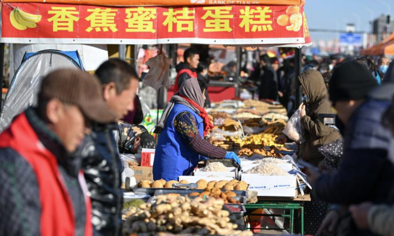 People visit an open-air market in Ninghe District of north China's Tianjin Municipality, Jan. 7, 2025. With a history of about 350 years, the market is one of the biggest countryside markets in Tianjin. (Xinhua/Sun Fanyue)