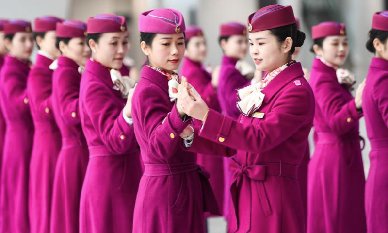 High-speed railway crew members take part in an etiquette training in Chongqing, southwest China, Jan. 8, 2025. The Chongqing branch of China Railway Chengdu Bureau Group Co., Ltd. organized training programs for high-speed railway crew members to improve service quality and prepare for the upcoming Spring Festival travel rush. (Xinhua/Wang Quanchao)