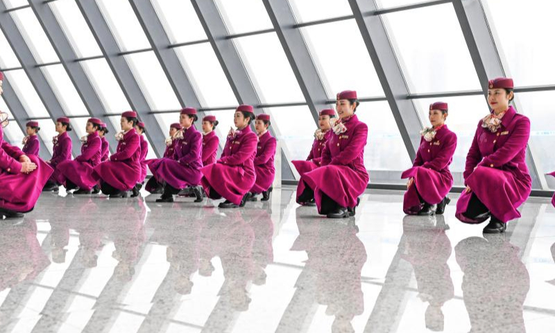 High-speed railway crew members take part in an etiquette training in Chongqing, southwest China, Jan. 8, 2025. The Chongqing branch of China Railway Chengdu Bureau Group Co., Ltd. organized training programs for high-speed railway crew members to improve service quality and prepare for the upcoming Spring Festival travel rush. (Xinhua/Wang Quanchao)