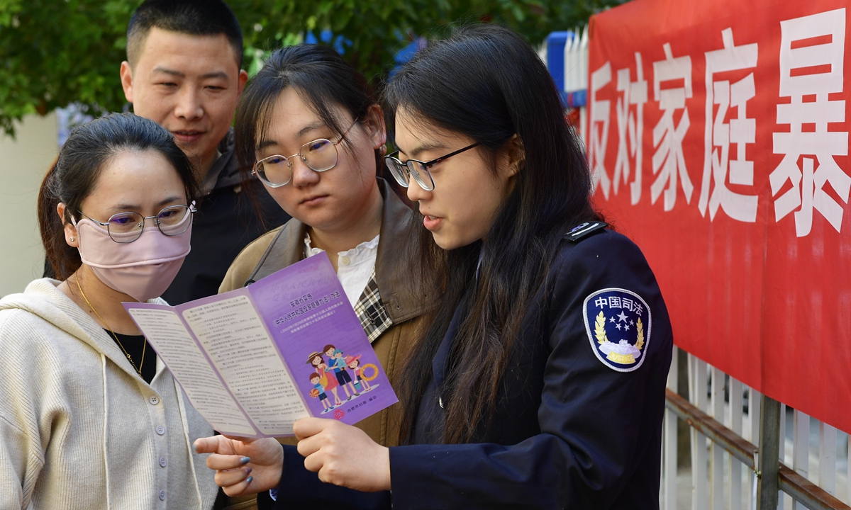 Judicial staff conduct an anti-domestic violence campaign among residents in Hefei, East China's Anhui Province, on November 21, 2024. Photo: VCG