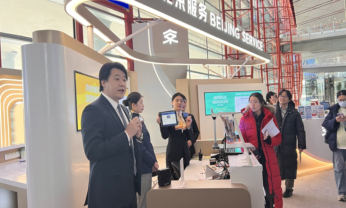 Employees at the Beijing Capital International Airport introduce their services to foreign passengers on January 8, 2025. Photo: Leng Shumei/GT