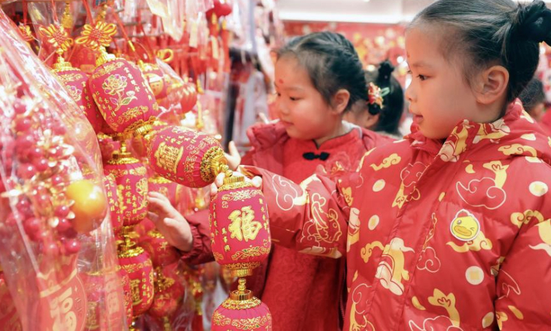 Children select Spring Festival decorations at a supermarket in Wuhan City, central China's Hubei Province, Jan. 17, 2025. Various activities were held across the country to welcome the upcoming Chinese New Year, or Spring Festival, which falls on Jan. 29 this year. (Photo by Zhao Jun/Xinhua)