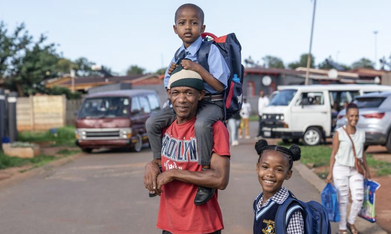 Students are seen with their parent on the first day of a new semester at a school in Johannesburg, South Africa, Jan. 15, 2025. Primary, secondary and preschool students in Johannesburg started a new semester this week. (Photo by Shiraaz Mohamed/Xinhua)