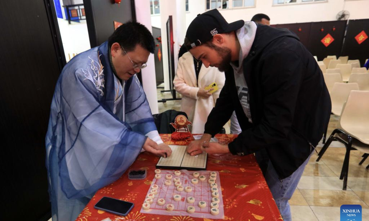 A student from Philadelphia University experiences Gobang during an event to celebrate the upcoming Chinese Spring Festival in Amman, capital of Jordan, Jan. 13, 2025. (Photo by Mohammad Abu Ghosh/Xinhua)