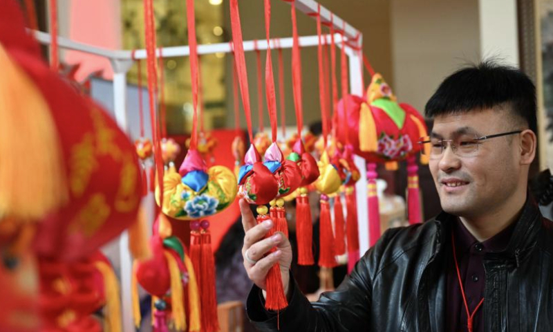 A man visits a decoration stall during an event welcoming the Chinese New Year in Islamabad, capital of Pakistan, on Jan. 11, 2025. An event welcoming the Chinese New Year, or Spring Festival, was held here on Saturday, with over 500 overseas Chinese and Pakistani guests participating. (Xinhua/Ahmad Kamal)