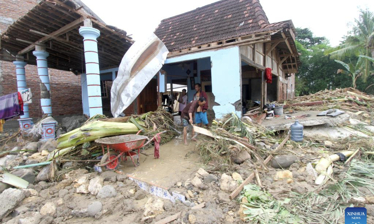 People clean their house after flash flood in Grobogan regency, Central Java, Indonesia, Jan. 22, 2025. (Photo by Bram Selo/Xinhua)