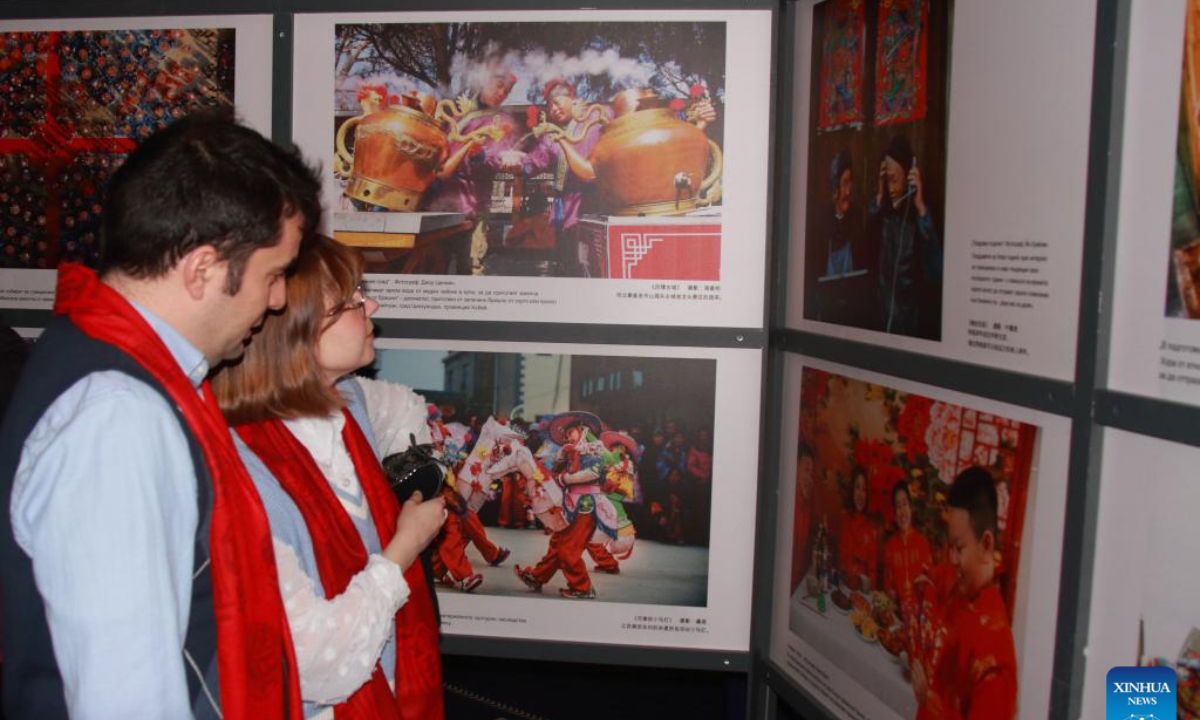 People visit a photography exhibition during a Spring Festival reception in Sofia, Bulgaria, Jan. 22, 2025. (Photo by Marian Draganov/Xinhua)