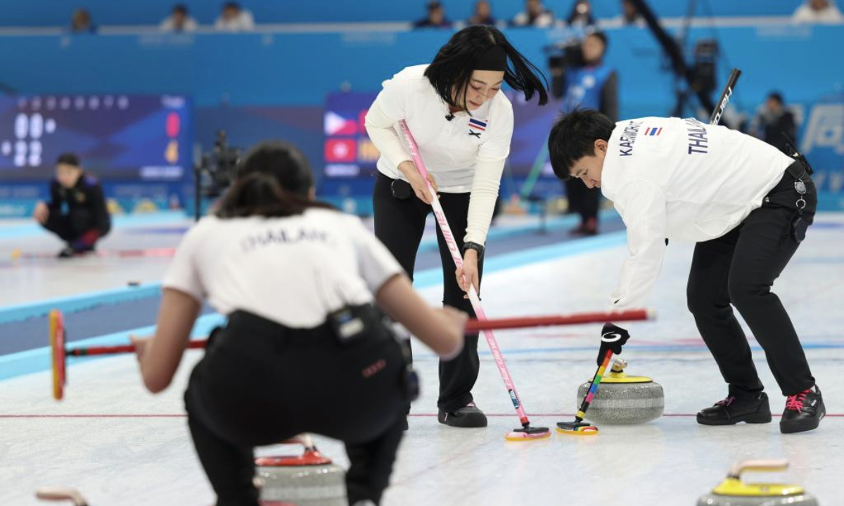 Kanya Natchanarong(C) and Supakan Kaewmorakot (R) of Thailand compete during the Women's Round Robin Session 1 match between China and Thailand of the curling event at the 9th Asian Winter Games in Harbin, northeast China's Heilongjiang Province, Feb. 9, 2025. (Xinhua/Hu Xingyu)