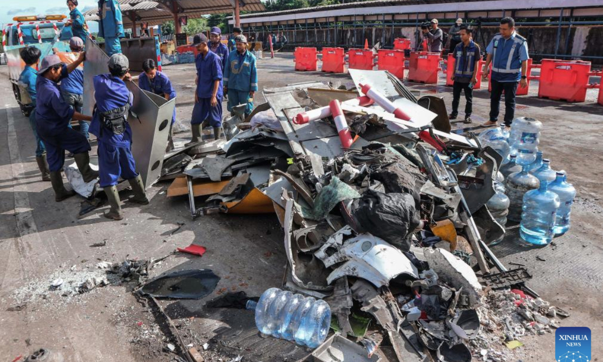 People collect the wreckage at the site of a traffic accident near the Ciawi Toll Gate in Bogor Regency, Indonesia, Feb. 5, 2025. Eight people were killed and 11 others were injured in a traffic accident in Indonesia's West Java province on Tuesday night, a senior official confirmed on Wednesday morning. (Photo by Rangga Firmansyah/Xinhua)