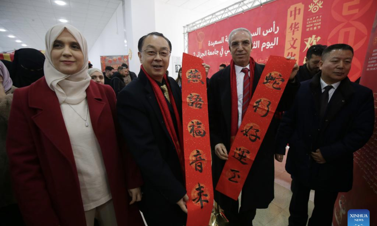 Chinese Ambassador to Algeria Dong Guangli (2nd L) shows a Spring Festival couplet at Algiers 2 University in Algeria, Jan. 20, 2025.

The Algiers 2 University celebrated the Chinese New Year on Monday with a vibrant event, featuring a range of cultural displays on campus that showcased Chinese traditional paintings, calligraphy, paper cutting, and clothing. (Xinhua)