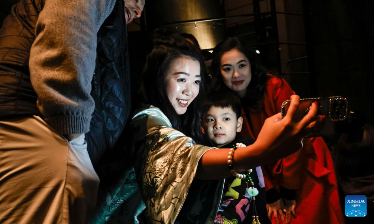 Attendees pose for a selfie at the Chinese New Year Showcase in Chicago, the United States, Feb. 1, 2025. (Photo by Joe Lerner/Xinhua)