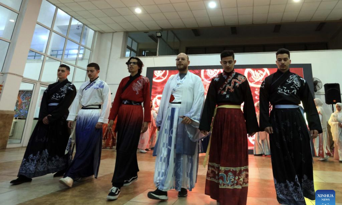 Students from Philadelphia University present Hanfu attire during an event to celebrate the upcoming Chinese Spring Festival in Amman, capital of Jordan, Jan. 13, 2025. (Photo by Mohammad Abu Ghosh/Xinhua)