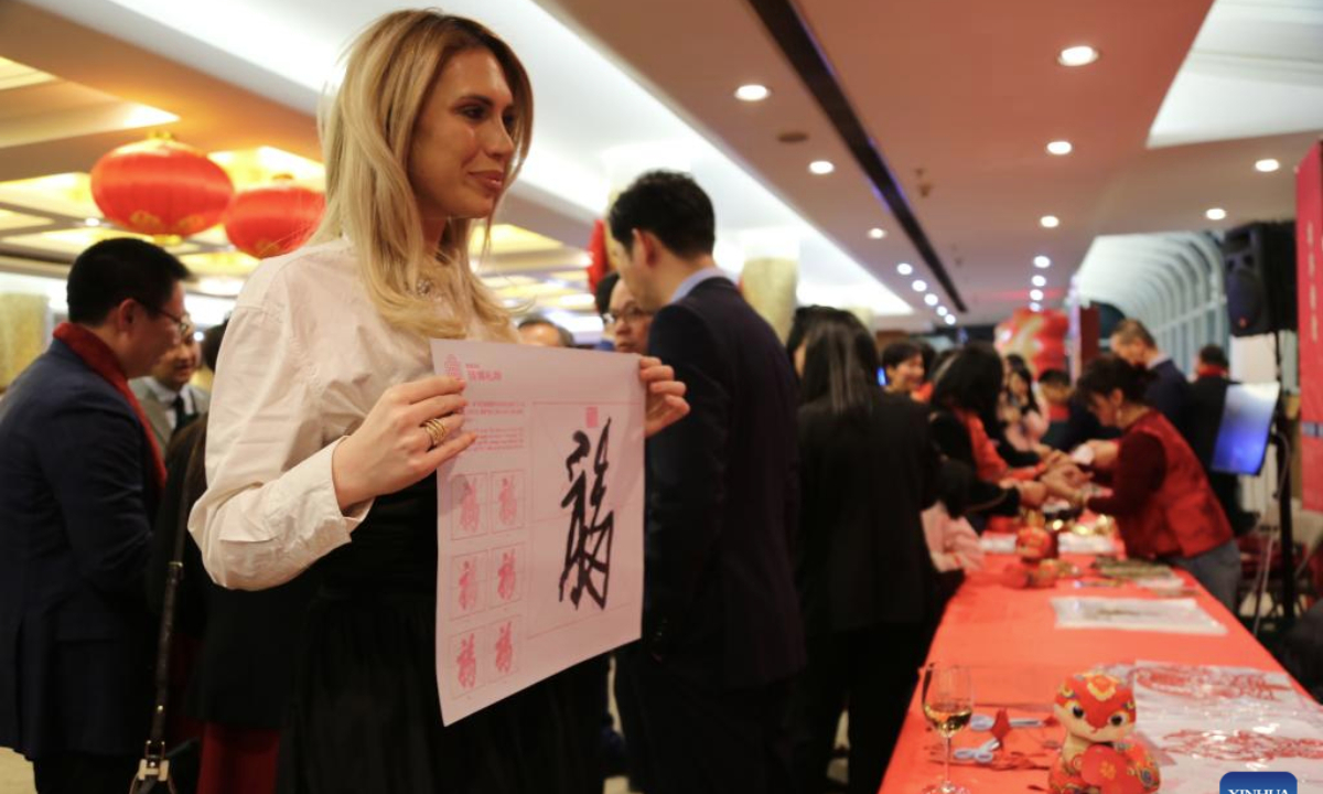 A guest demonstrates her calligraphy work of Fu during the 2025 Spring Festival reception at the Chinese Consulate General in New York, on Jan. 23, 2025. (Xinhua/Liu Yanan)