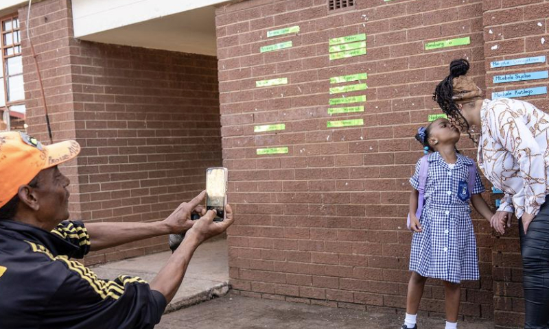 A student and her parent pose for photos on the first day of a new semester at a school in Johannesburg, South Africa, Jan. 15, 2025. Primary, secondary and preschool students in Johannesburg started a new semester this week. (Photo by Shiraaz Mohamed/Xinhua)