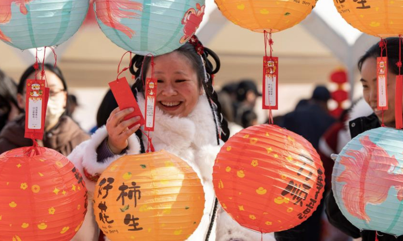 Citizens take part in a riddle game during an event celebrating the upcoming Spring Festival in Jinhua City, east China's Zhejiang Province, Jan. 17, 2025. Various activities were held across the country to welcome the upcoming Chinese New Year, or Spring Festival, which falls on Jan. 29 this year. (Photo by Hu Xiaofei/Xinhua)