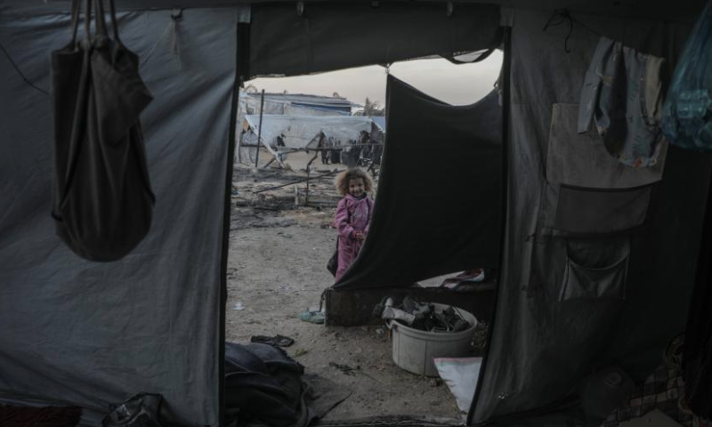 A girl is seen at the site of destroyed tents after an Israeli bombardment, in Deir al-Balah city in the central Gaza Strip, on Jan. 14, 2025. (Photo by Rizek Abdeljawad/Xinhua)