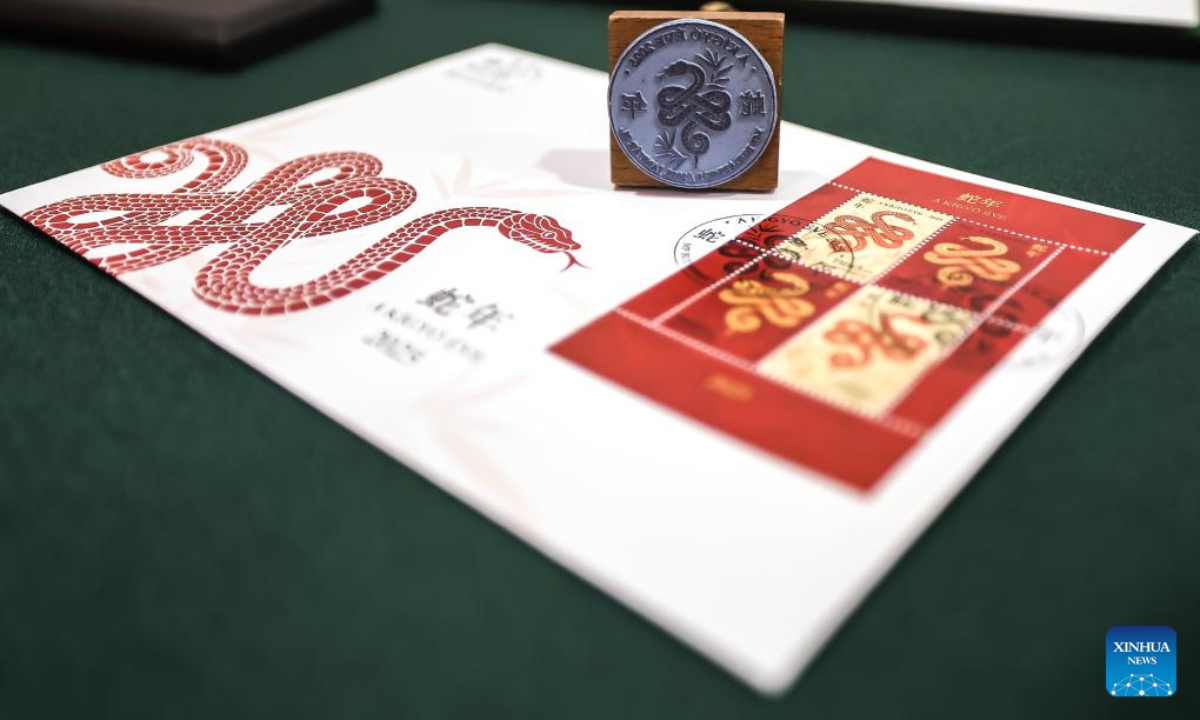 Photo taken on Jan. 21, 2025 shows a first-day cover with the stamps of the Year of the Snake at a launch ceremony in Budapest, Hungary. A commemorative sheet of postage stamps celebrating the upcoming Chinese Lunar New Year, the Year of the Snake, was unveiled on Tuesday at the China Cultural Center in Budapest, Hungary. (Photo by David Balogh/Xinhua)